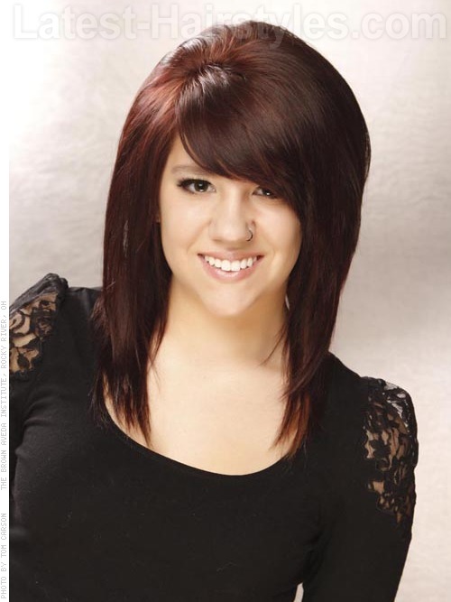 A medium haircut with dark red hair color