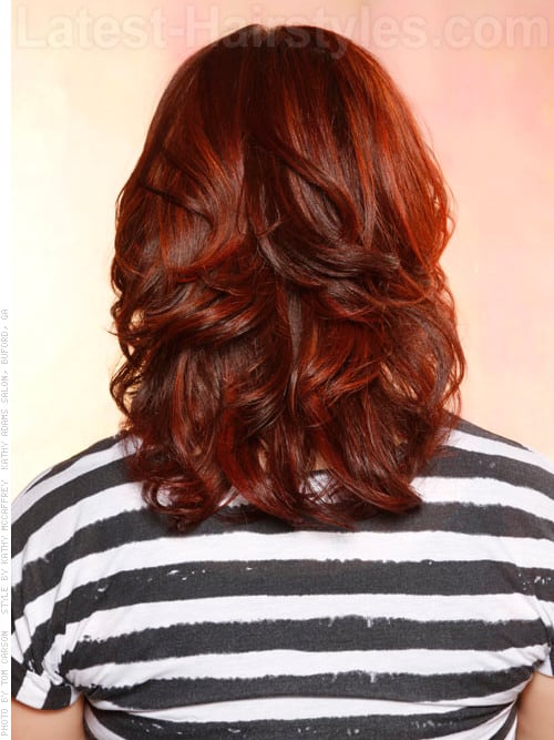 Dark colored hairstyle with layers and waves back view