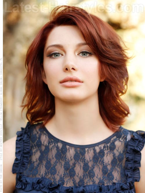 A medium length hairstyle with auburn red hair color