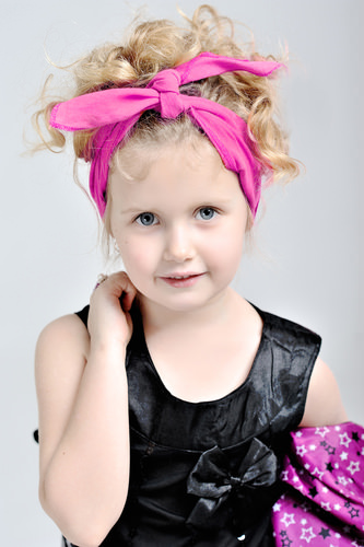 Cute Curly Blonde Style with a Pink Bow