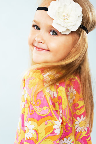 Hippie Girl Fun Straight Blonde Hairstyle with Big Flower Hair Accessory for a Little Girl