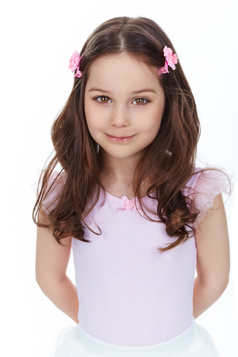 Soft Waves Brunette Hairstyle with Pink Barrettes for a Little Girl