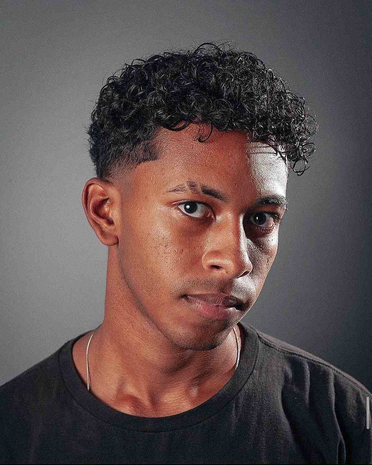 Asymmetrical Curly Fringe and Taper Fade for Guys
