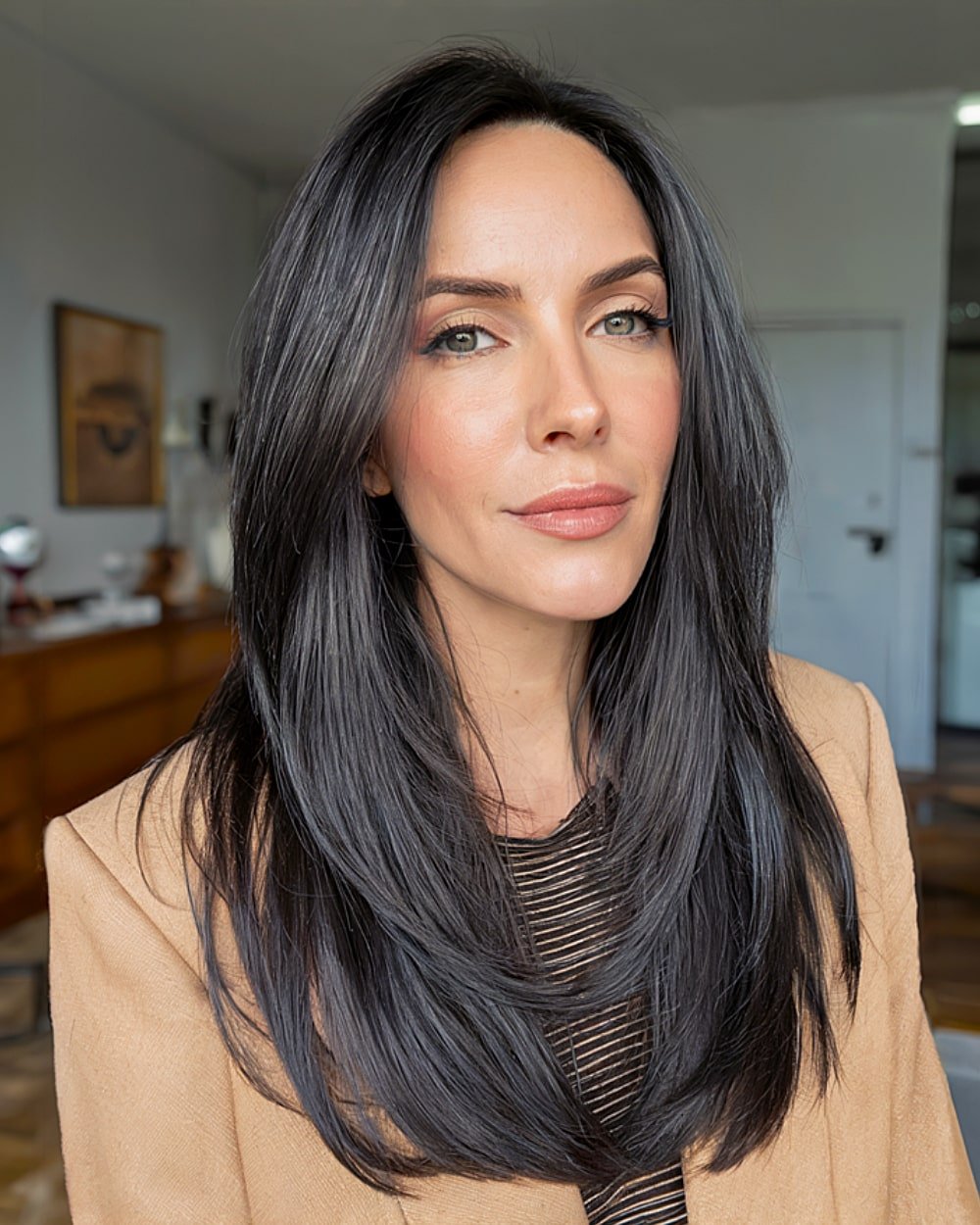 Long black layered hair with sharp face-framing and sleek alt finish