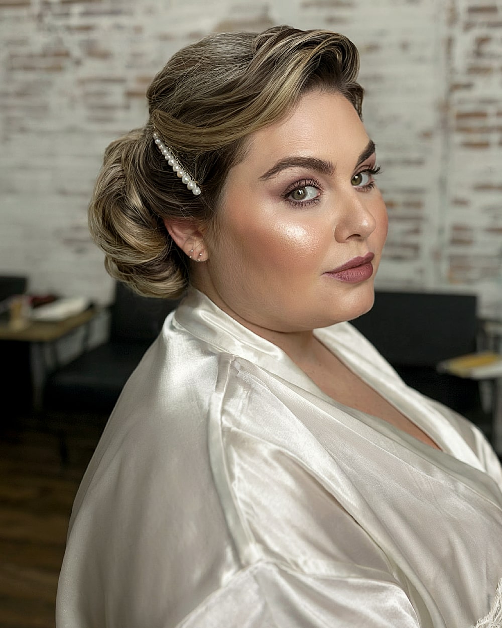 Elegant bridal French twist with vintage waves and pearl hair clip