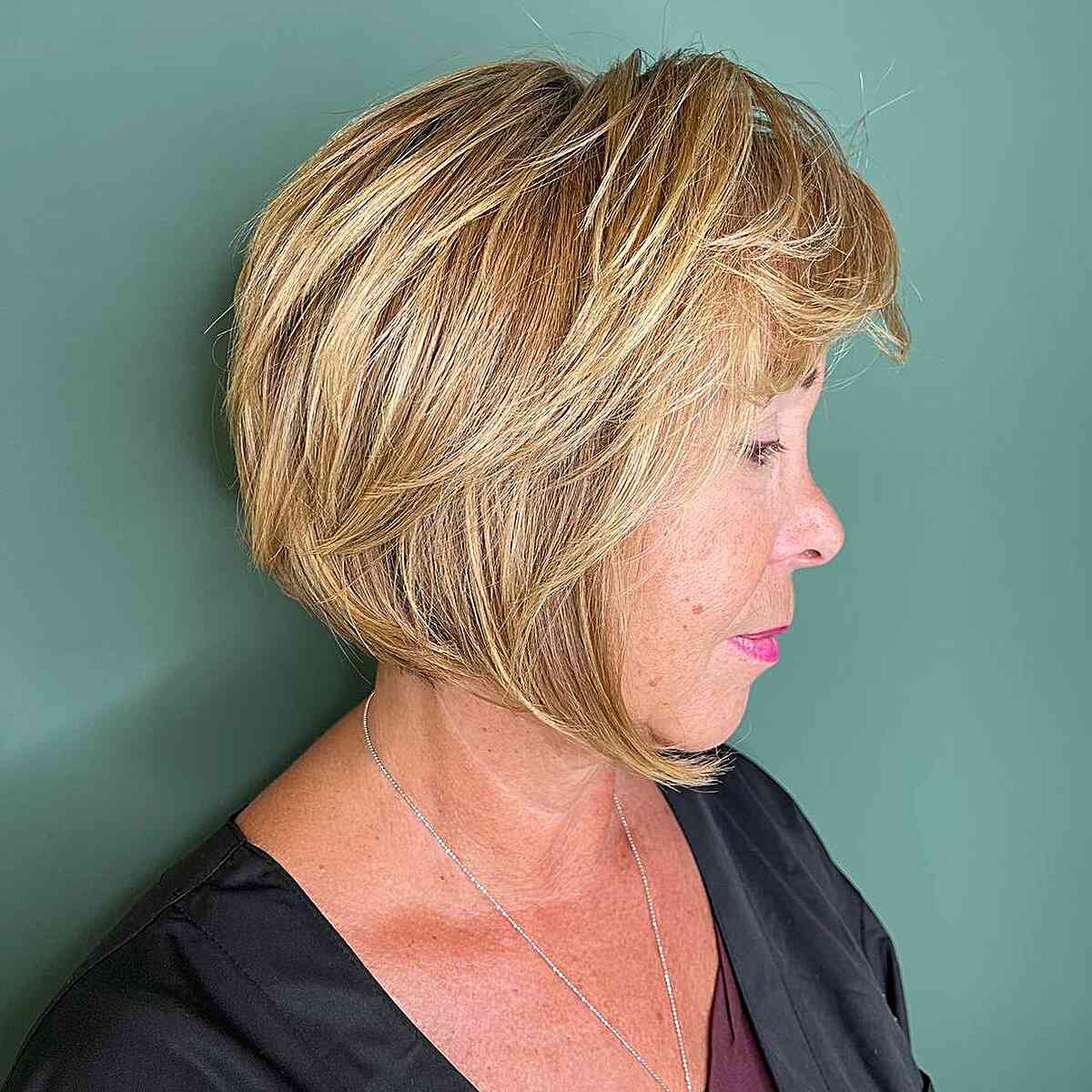 Chin-Length Bob Cut with Angled Layers and Bangs on women past their 60s