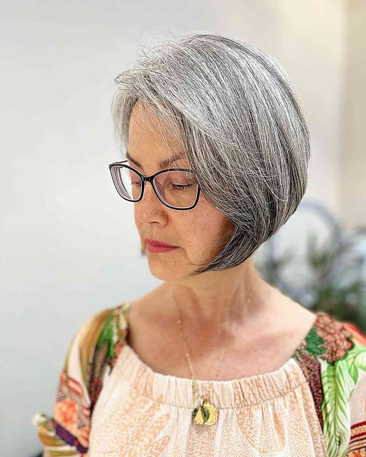 Chin-Length Grey Bob with Side Part for Women Aged 60 with Thick Tresses