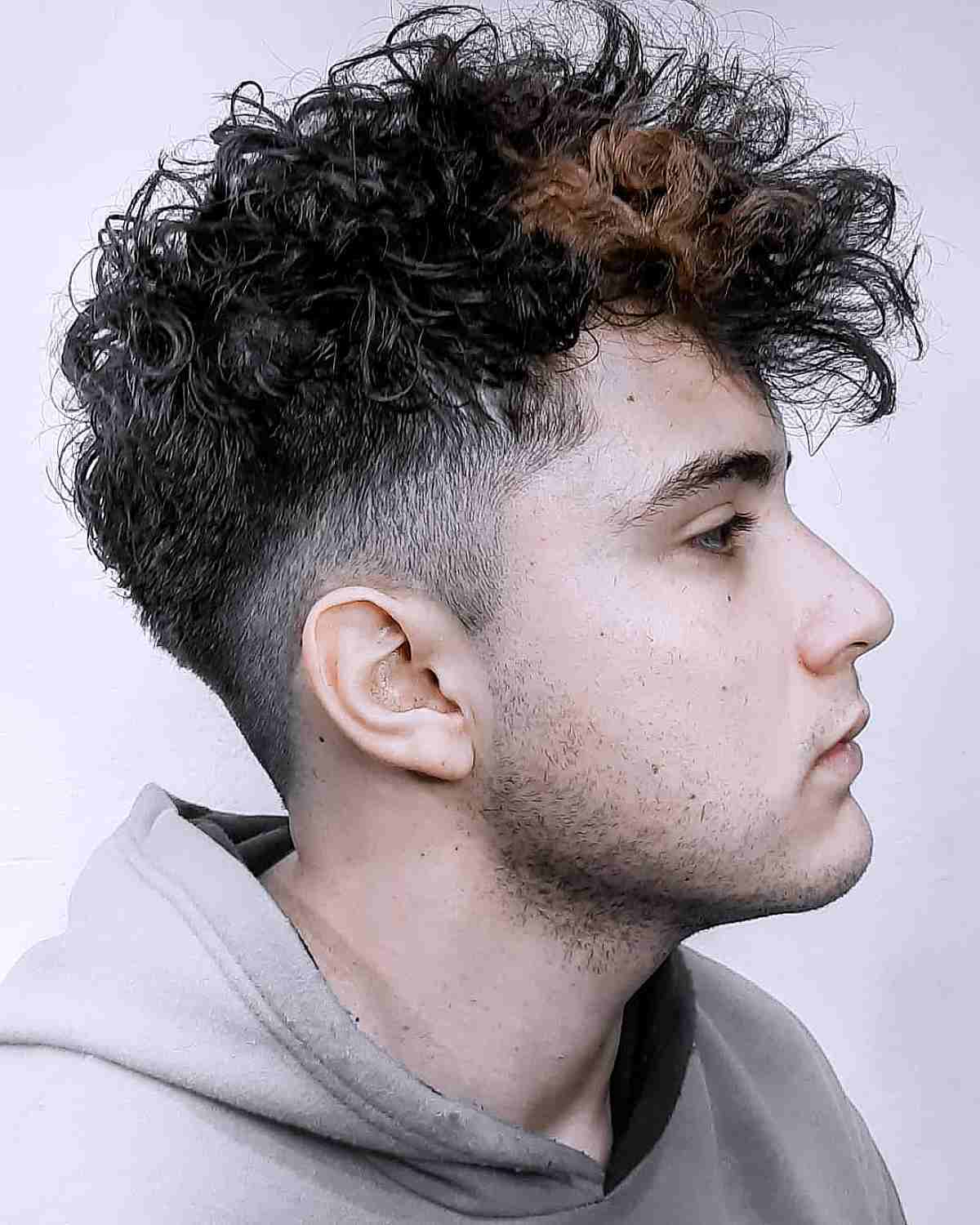 Choppy curls with an undercut fade