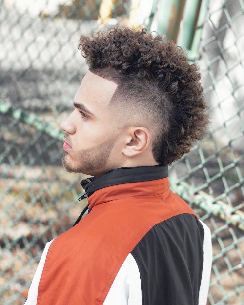 A imitation hawk fade is a type of fade that complements a imitation hawk hairstyle yesteryear adding contra xv Lit Faux Hawk Fade Haircuts for Guys