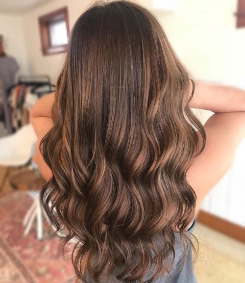 Picture of a dashing long caramel brown balayage for olive skin
