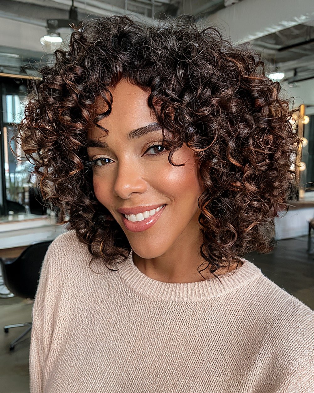 Defined curls in stacked bob cut with glossy ringlets and rounded silhouette