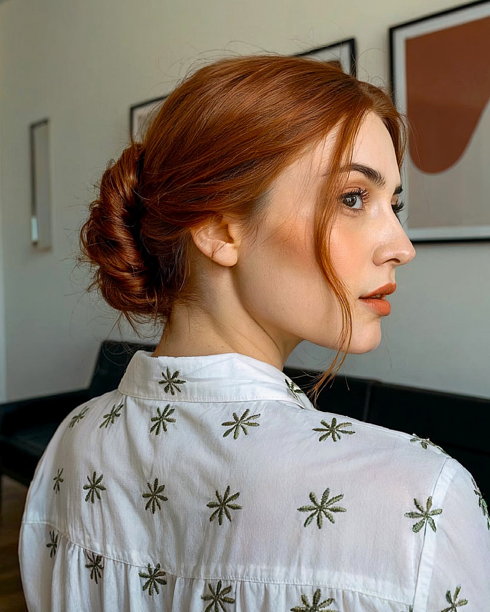 Soft French twist for long red hair with loose texture and natural finish
