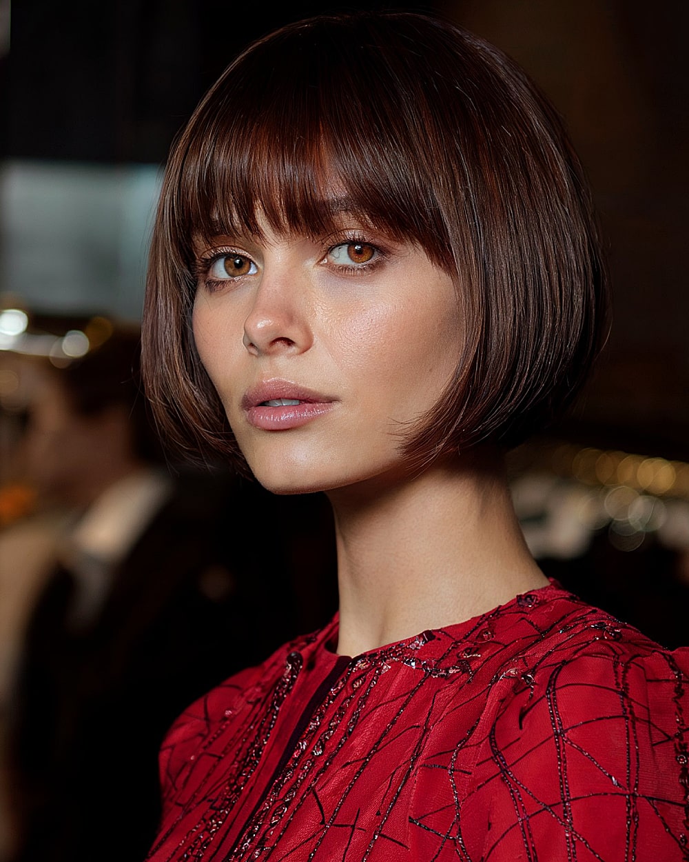 Round pinch bob with brow-length fringe and micro-tapered sides on medium hair