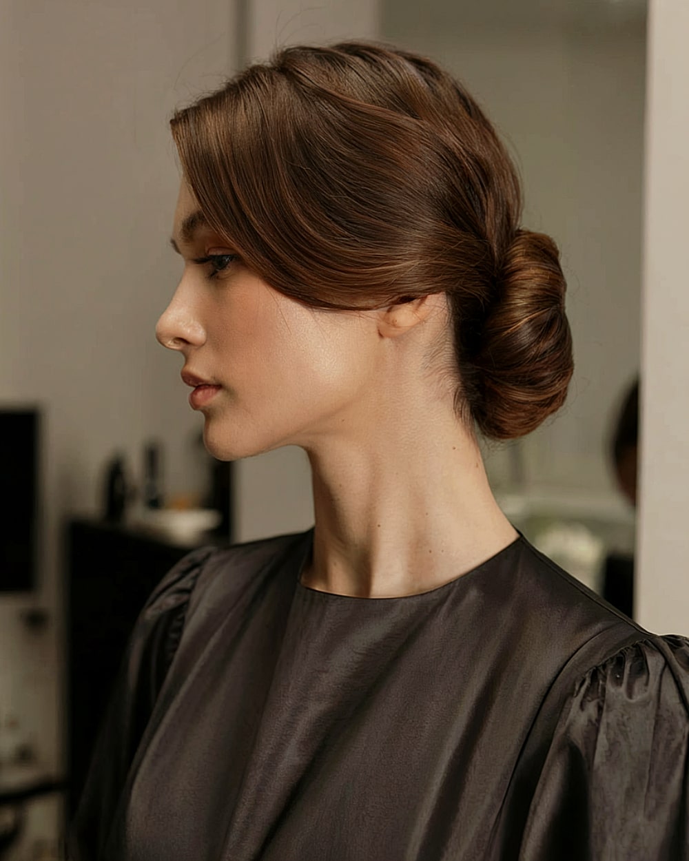 Elegant twisette updo with sleek finish and side-parted front for formal wear