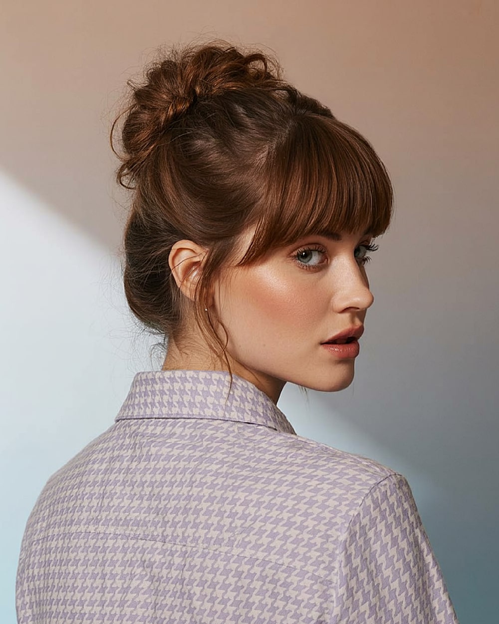 French twist updo with full bangs and wispy strands for modern style