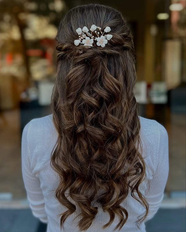 Romantic Half-Up Half-Down Curly Elegance with Floral Detail