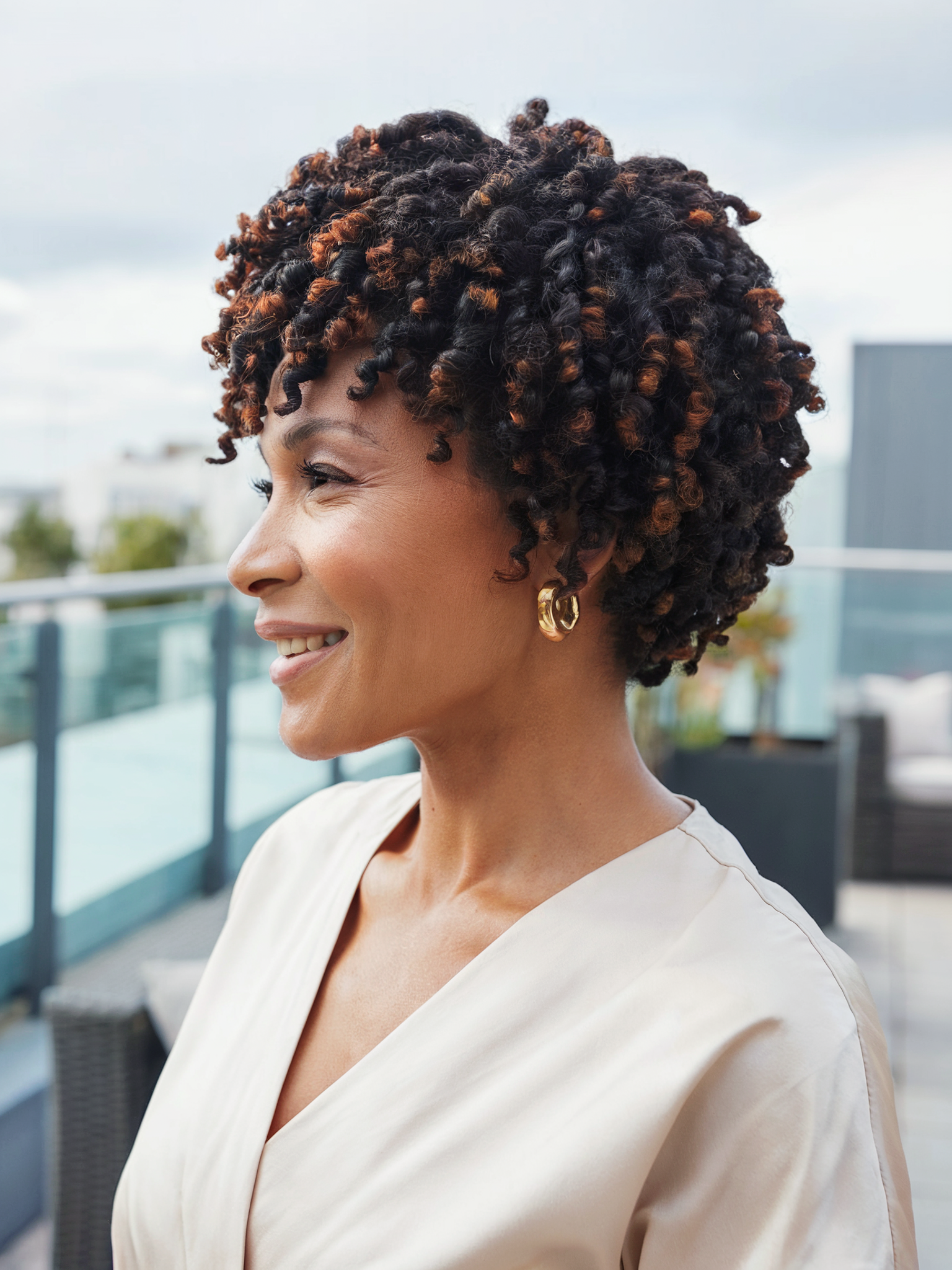 Chic Short Natural Curls with Warm Copper Highlights