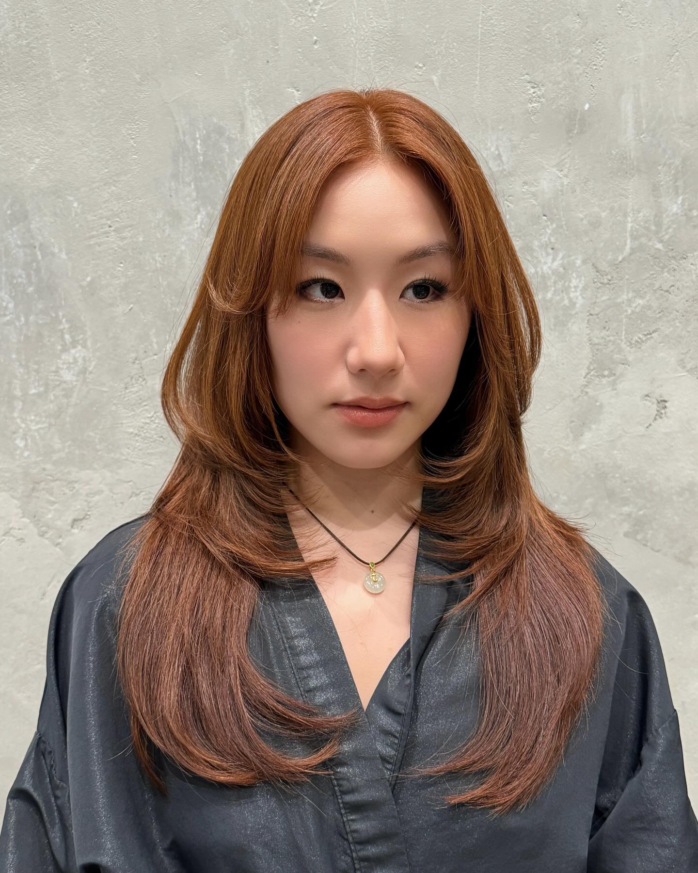 Layered Hush Cut with Subtle Movement and Warm Auburn Tones