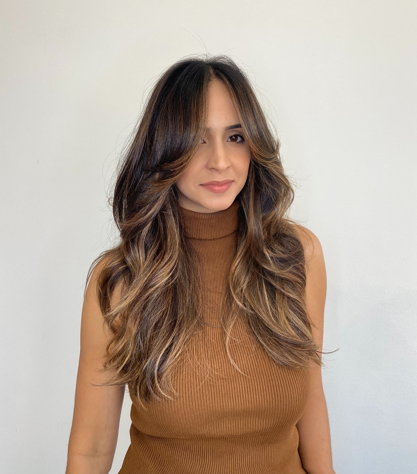 Elegant Layered Hush Cut with Soft Face-Framing Strands