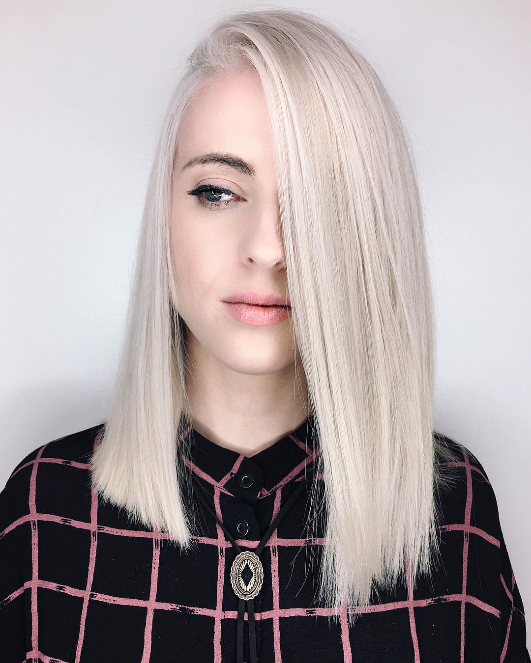 Sleek Asymmetrical Light Blonde Cut with Bold Side Part