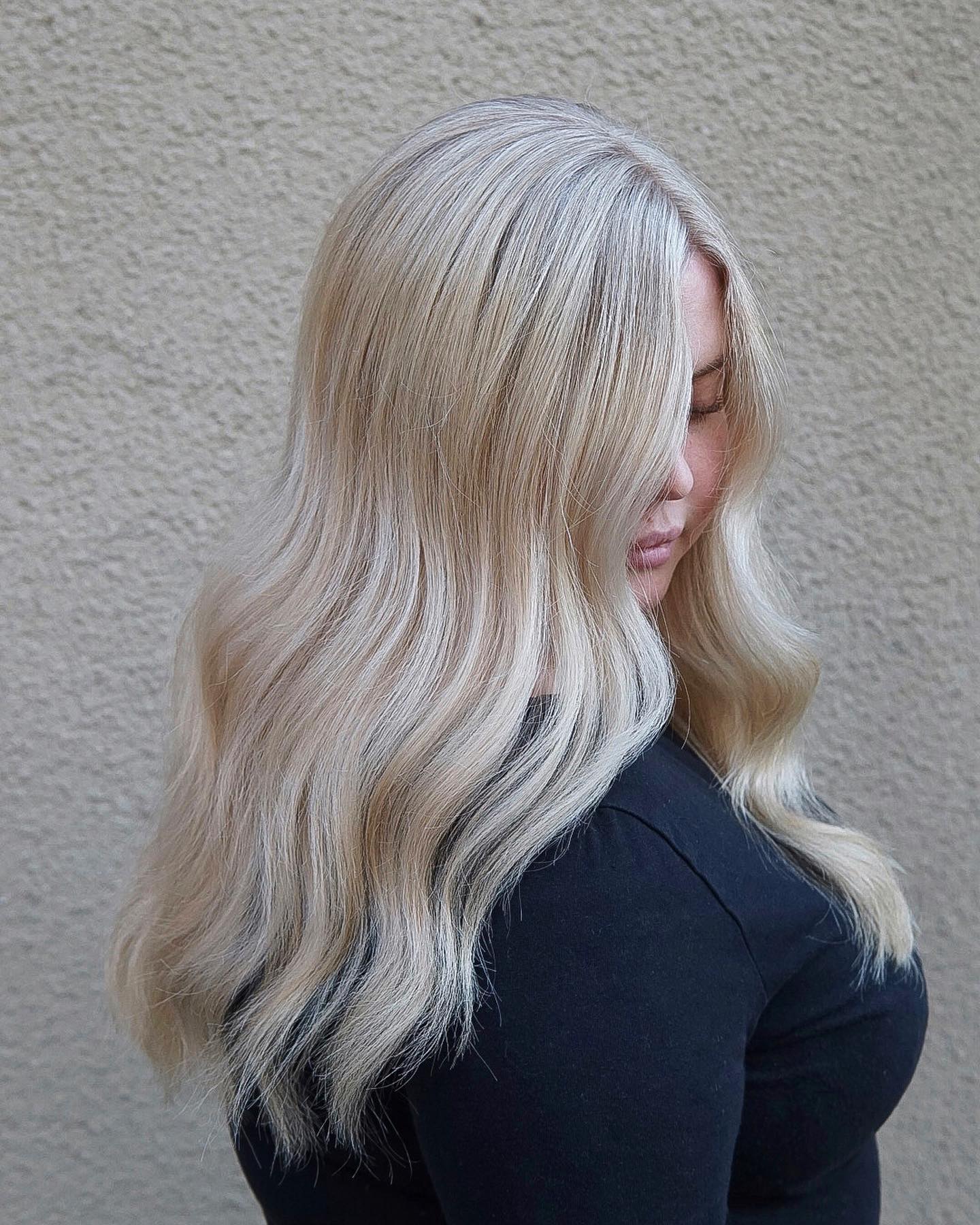 Stylish Light Blonde Waves with Subtle Root Shadow