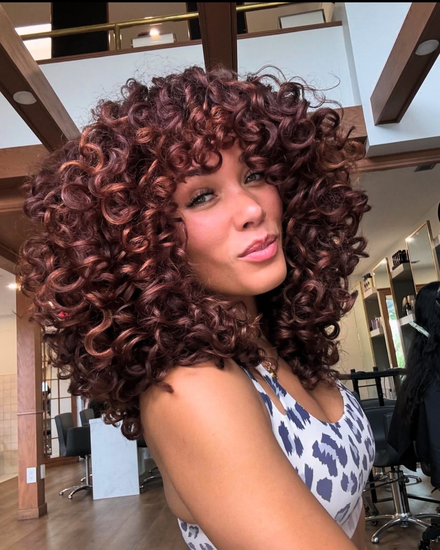 Bold Curly Layers with Reddish Undertones