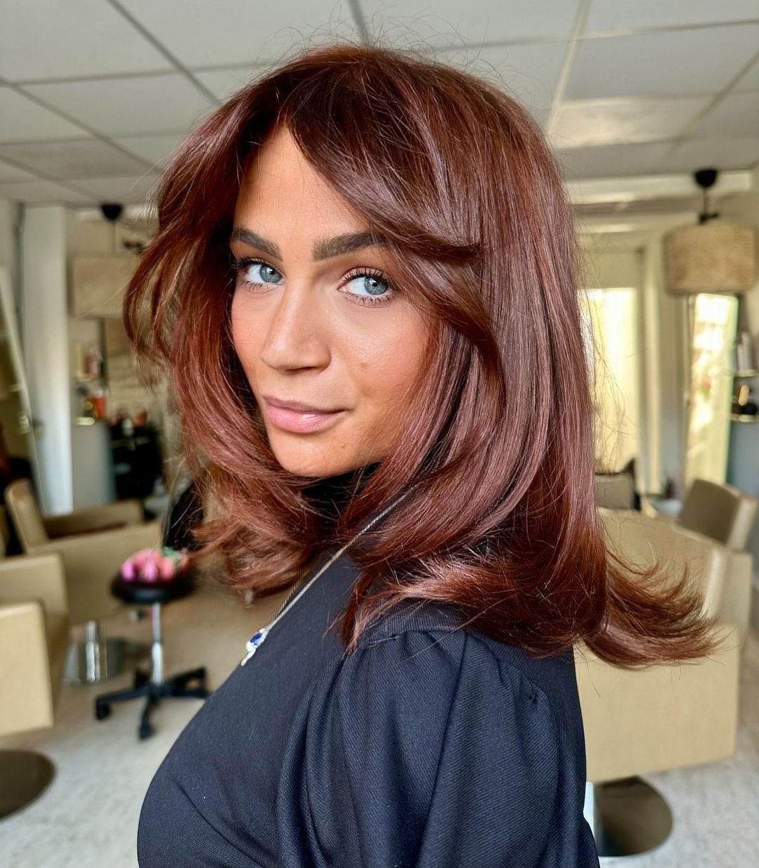 Modern Layered Copper Haircut with Face-Framing Bangs