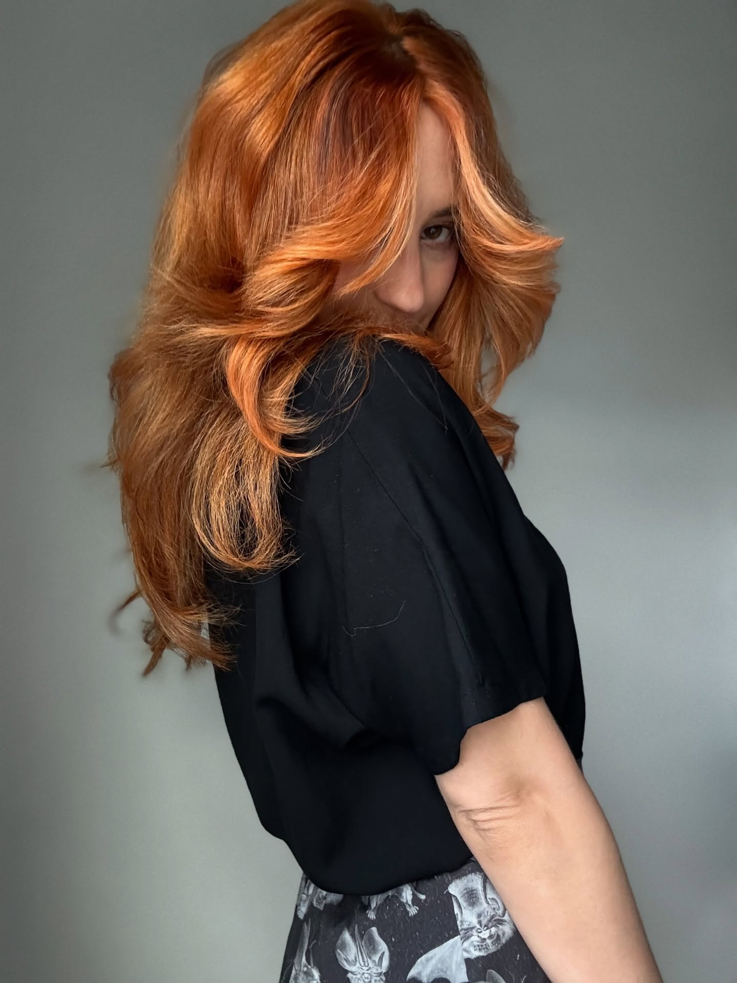 Vibrant Long Layered Copper Hair with Soft Face-Framing Waves