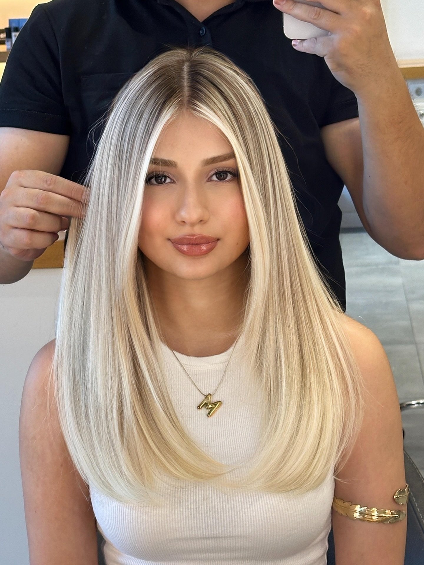 Platinum Blonde Feathered Layers with Face-Framing Highlights