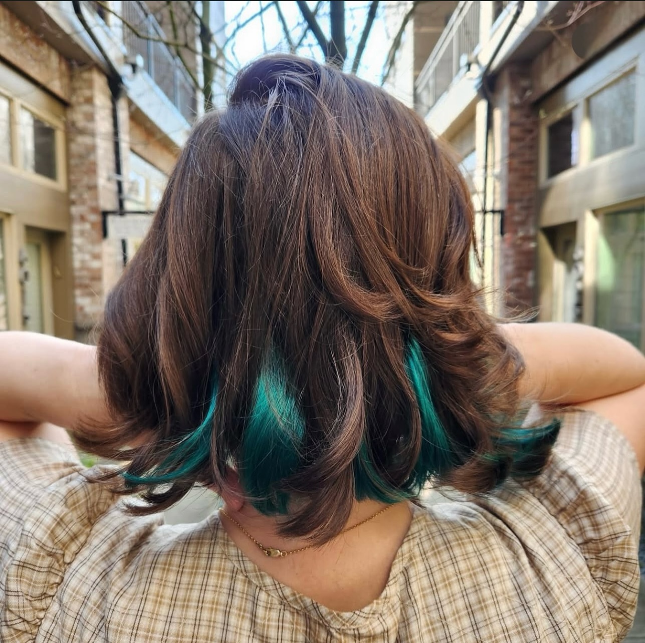Brunette Bob with Vibrant Teal Highlights