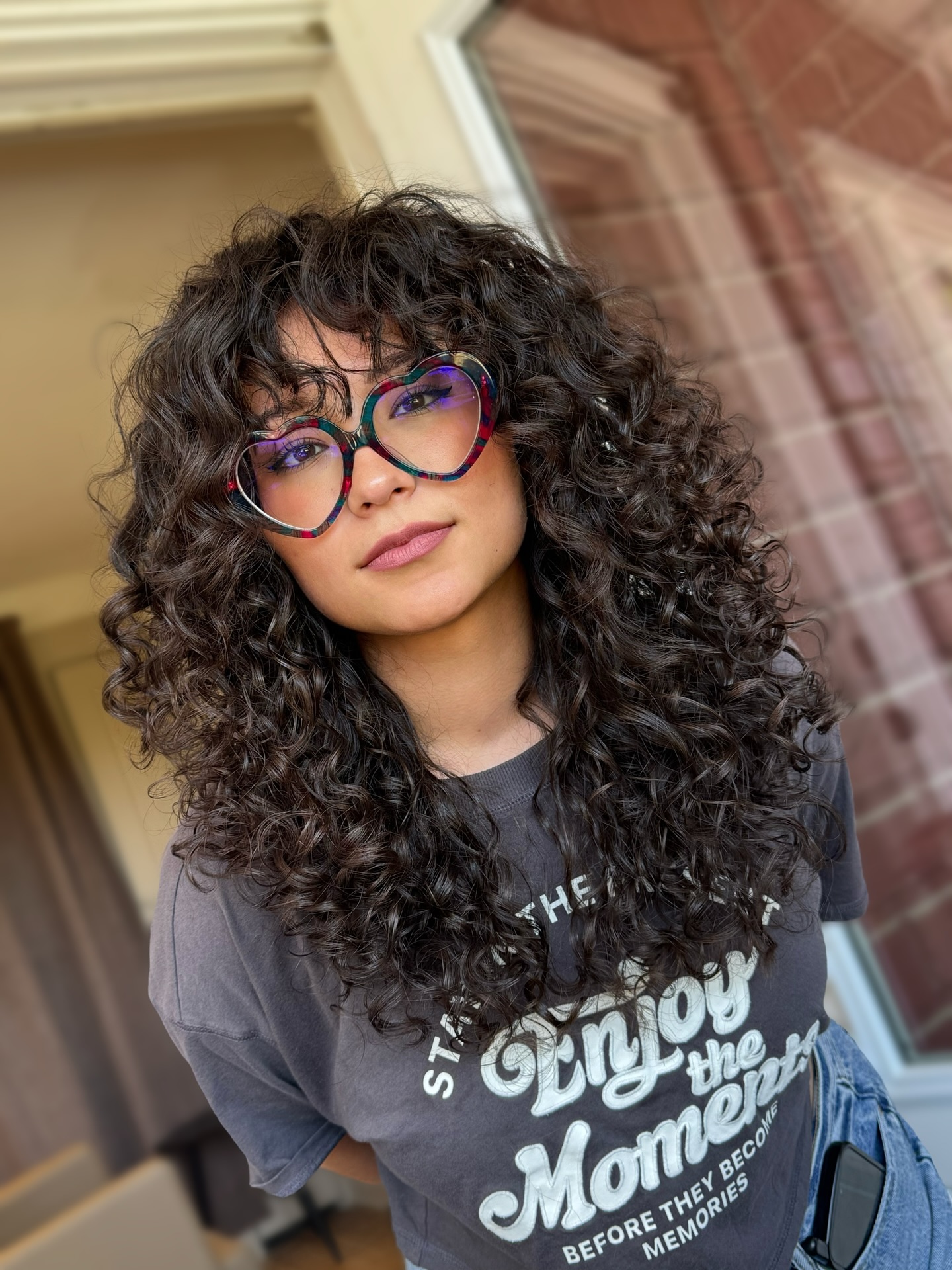 Natural Voluminous Chestnut Curls with Soft Bangs