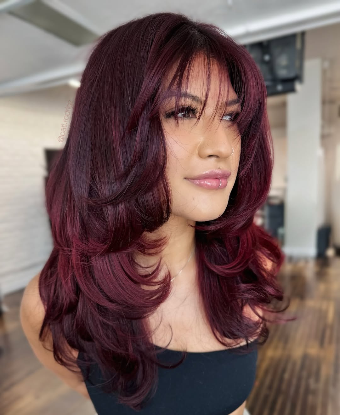 Voluminous Red Cherry Layered Cut with Face-Framing Bangs