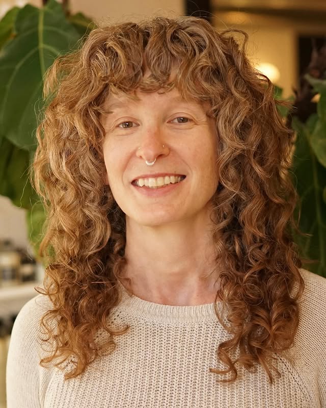 Naturally Tousled Chestnut Curls with Delicate Highlights