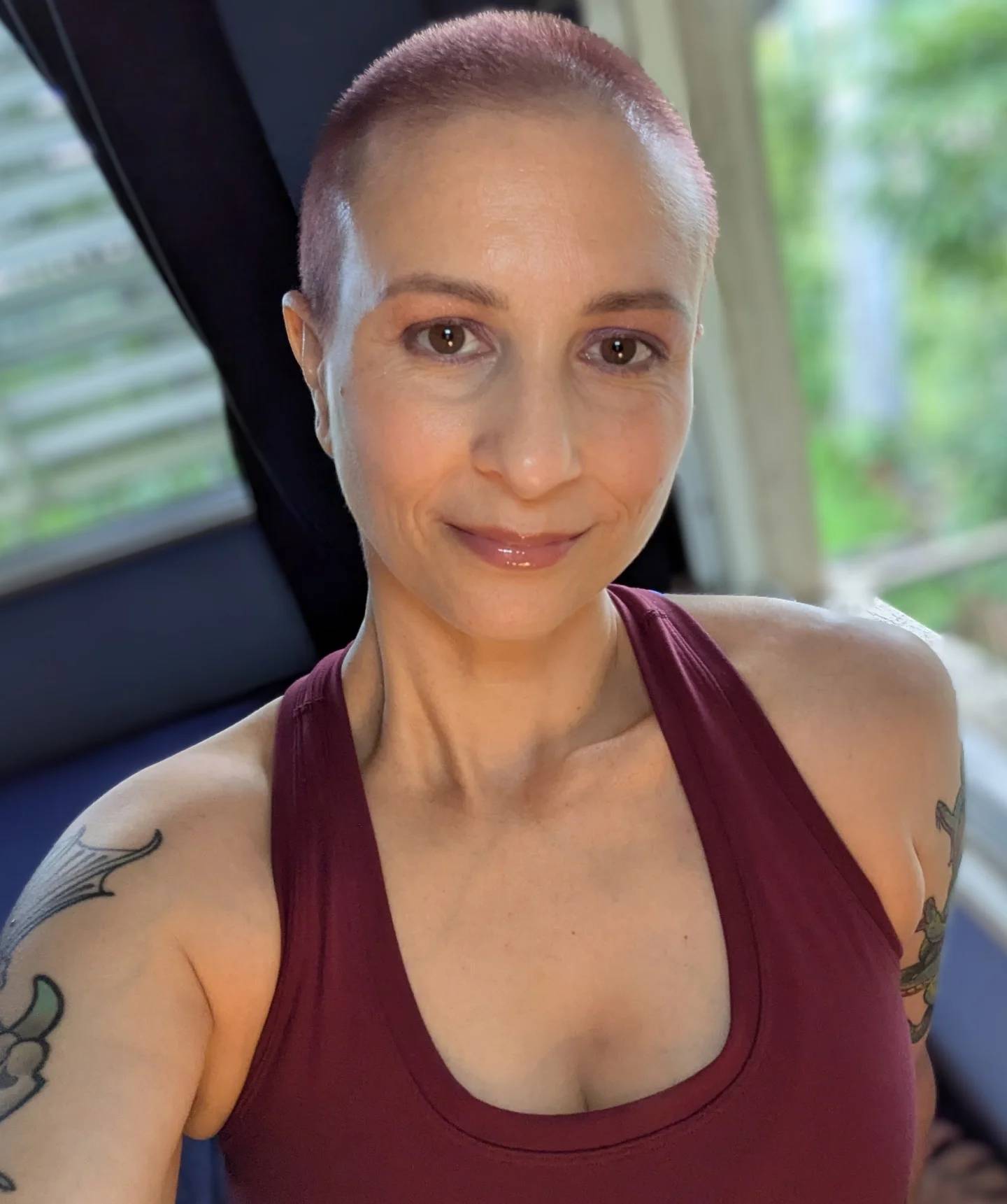 Bold Close-Cropped Buzz Cut with Subtle Rose Tones