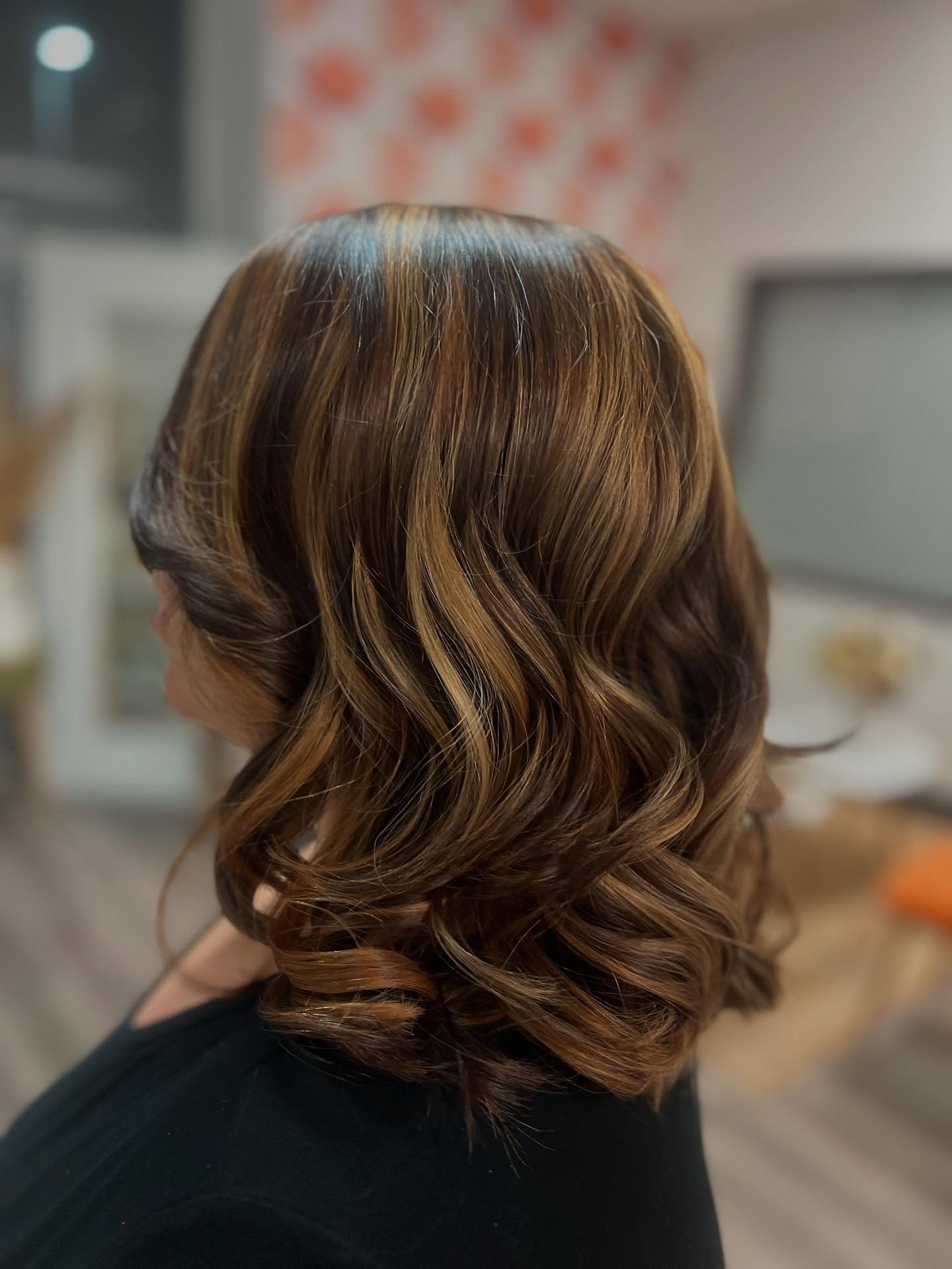 Warm Caramel Highlights on Soft Curly Brown Hair
