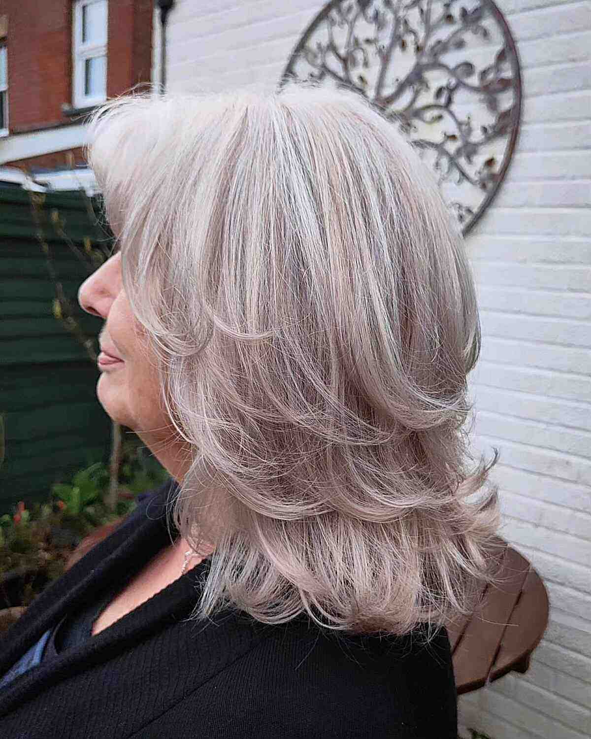 Grey Highlights and Mid-length Swoopy Layers for 50-Year-Old Women