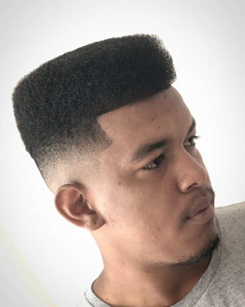 is a haircut for dark men alongside a long afro on top that The 12 Best High Top Fade Haircuts You’ll See