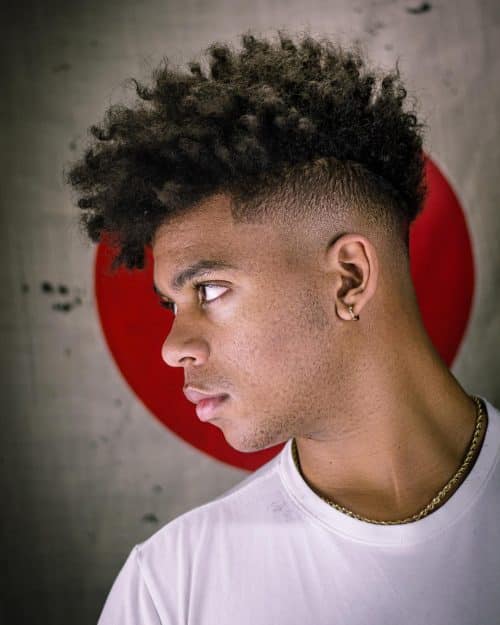 is a haircut for dark men alongside a long afro on top that The 12 Best High Top Fade Haircuts You’ll See