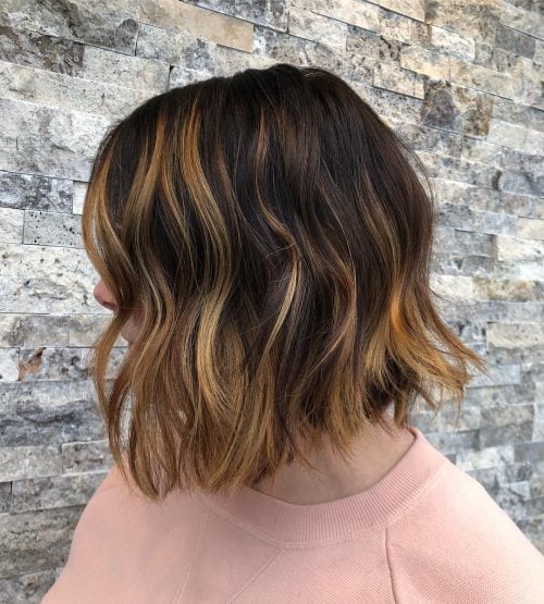 Short dark brown hair with caramel highlights