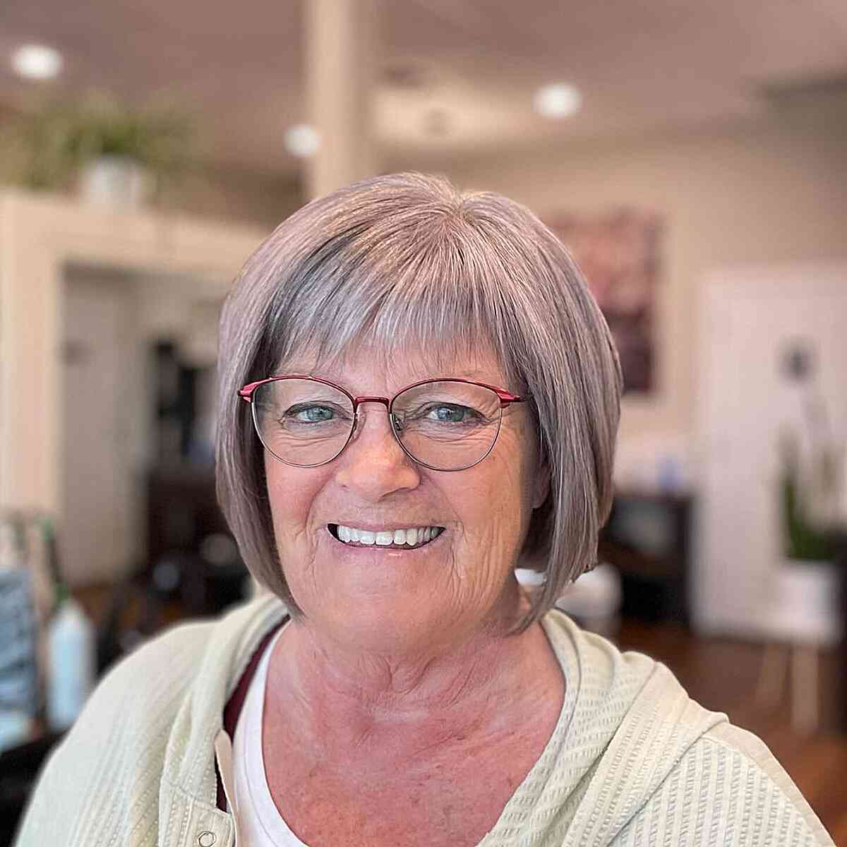 Short Icy Silver Bob with Choppy Bangs for Seniors Over Sixty with Glasses and Grey Hair