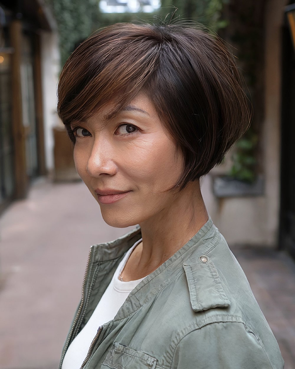 Inverted pixie bob with long front pieces and angled neckline for women over 40
