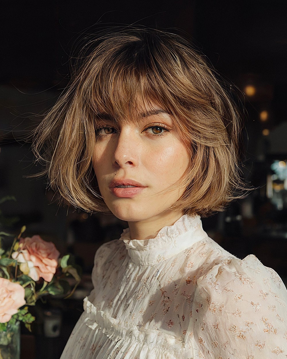 Tousled pinch bob with layered bangs and chin-length ends for fine to medium wavy hair