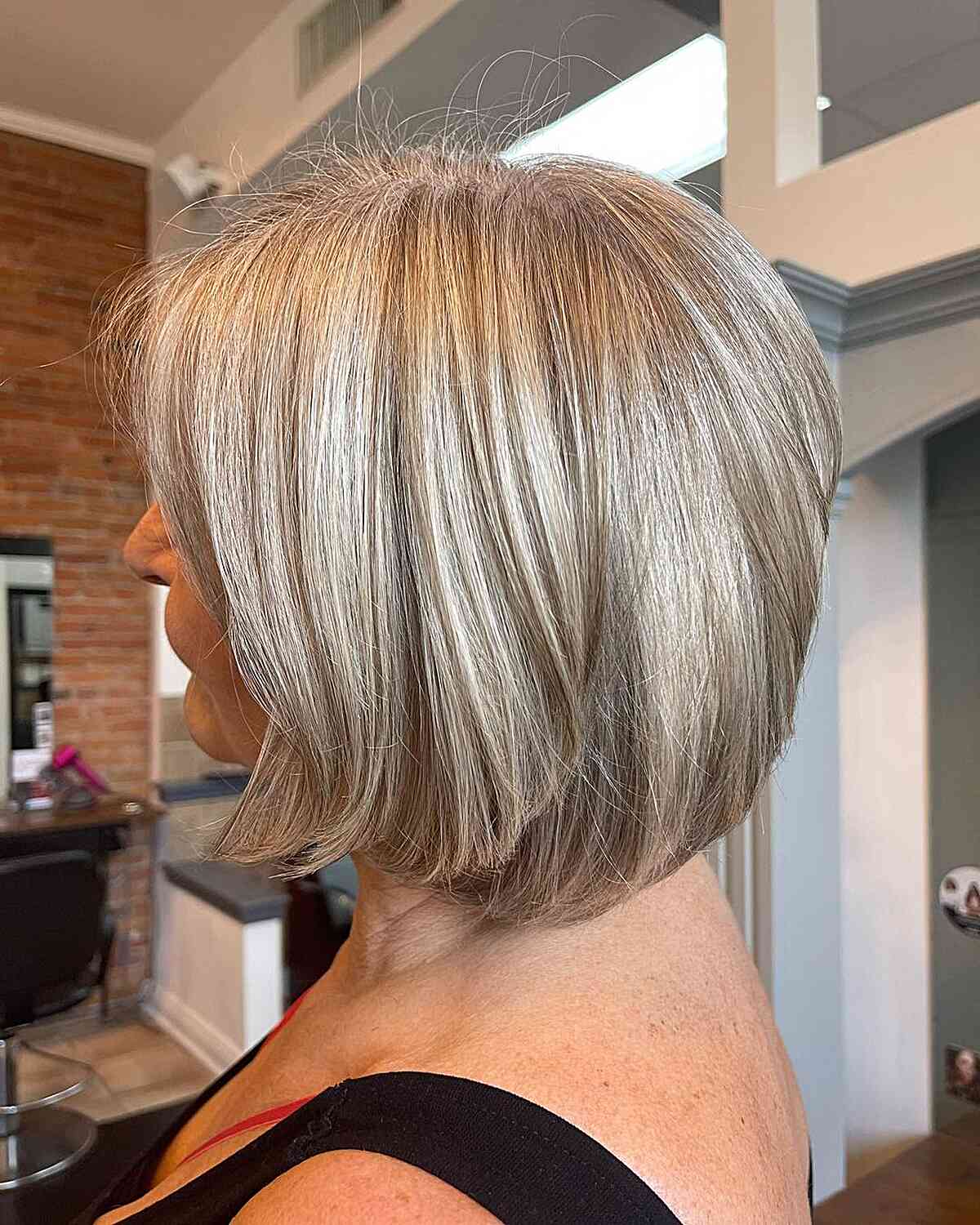 Neck-Length Layered Bob with Beige Silver Highlights for Mature Women with Grey Hair
