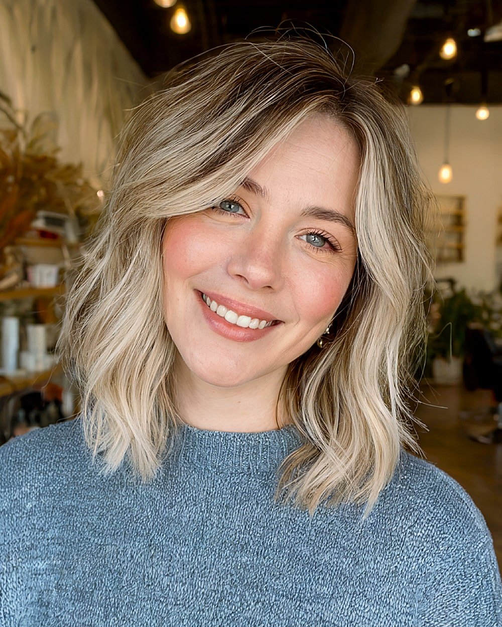 Textured blonde layered lob with soft waves and dimensional lowlights for an alt-style haircut