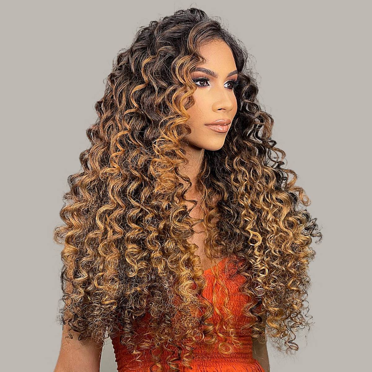 Image of Young woman with dark brown shaggy long curly hair