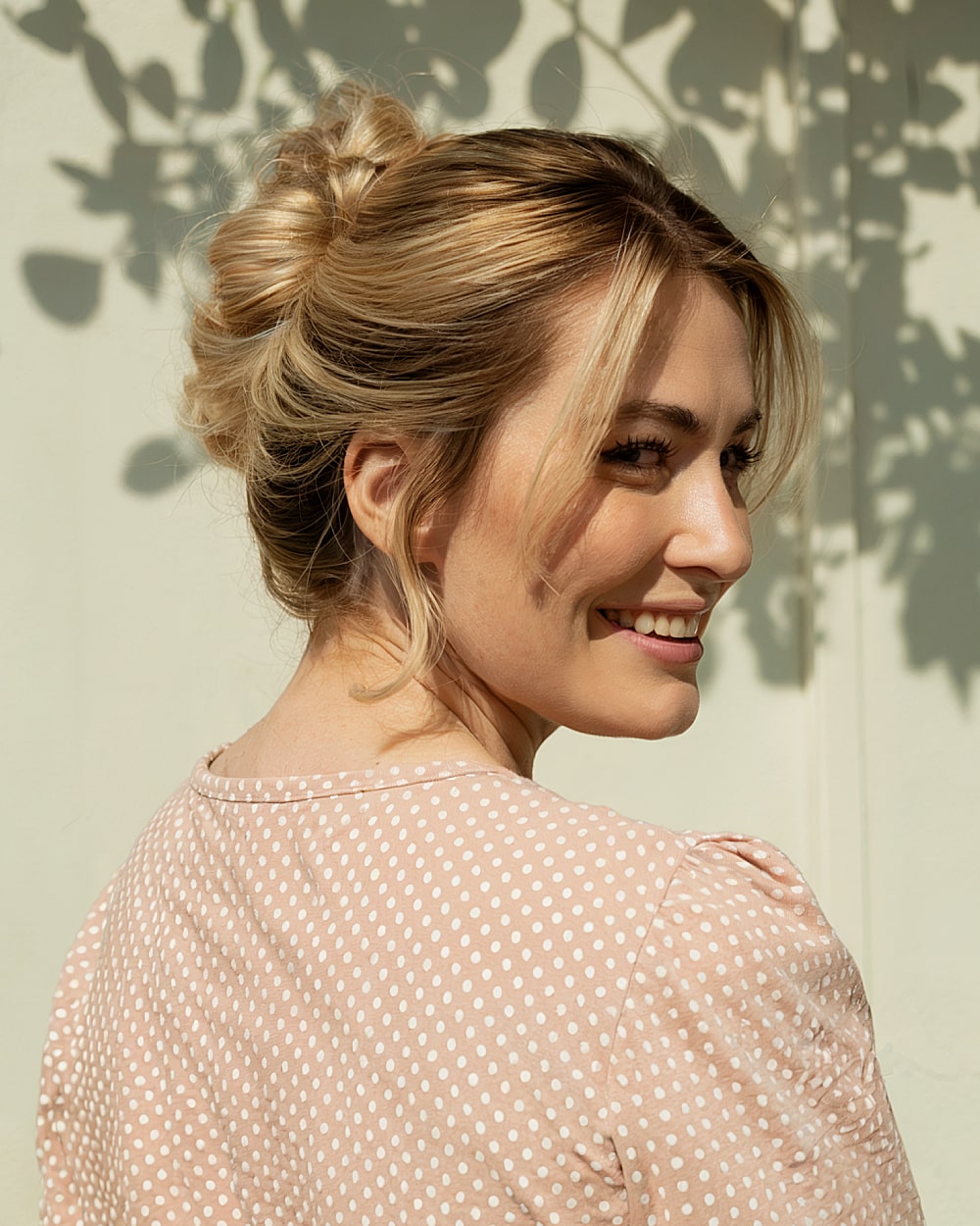 Loose French twist updo with soft waves and face-framing layers
