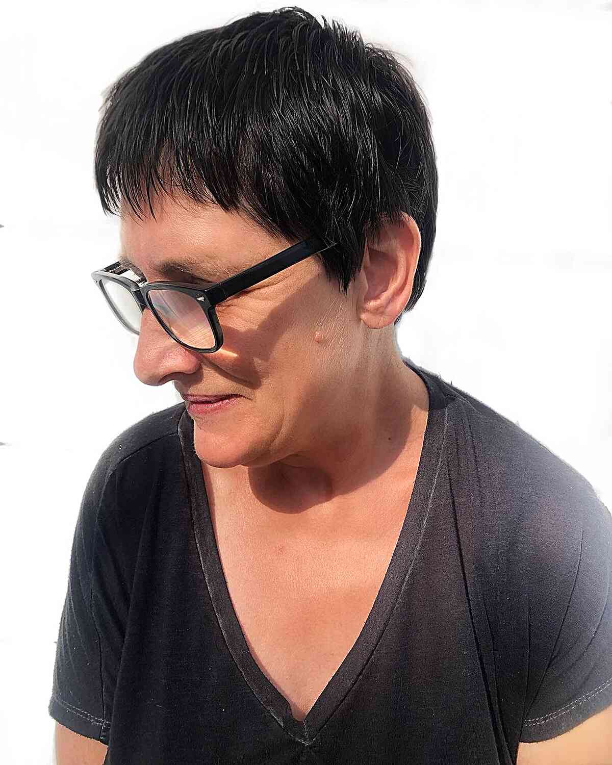 Low-Maintenance Short Pixie Hair with Choppy Bangs for Ladies Aged 50 with Eyeglasses