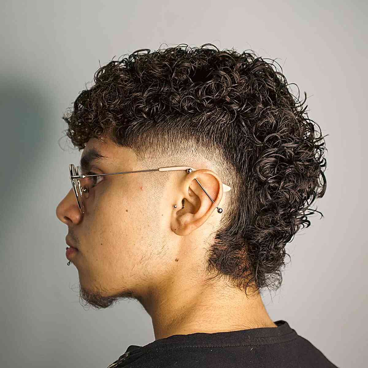 Low Mullet Burst Fade with Curls on Younger Men