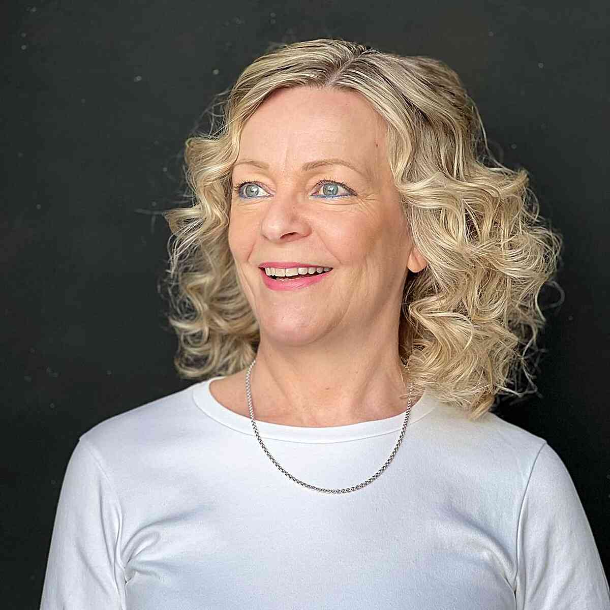 Medium Curly Layered Hair with Side Part for Women Over 60