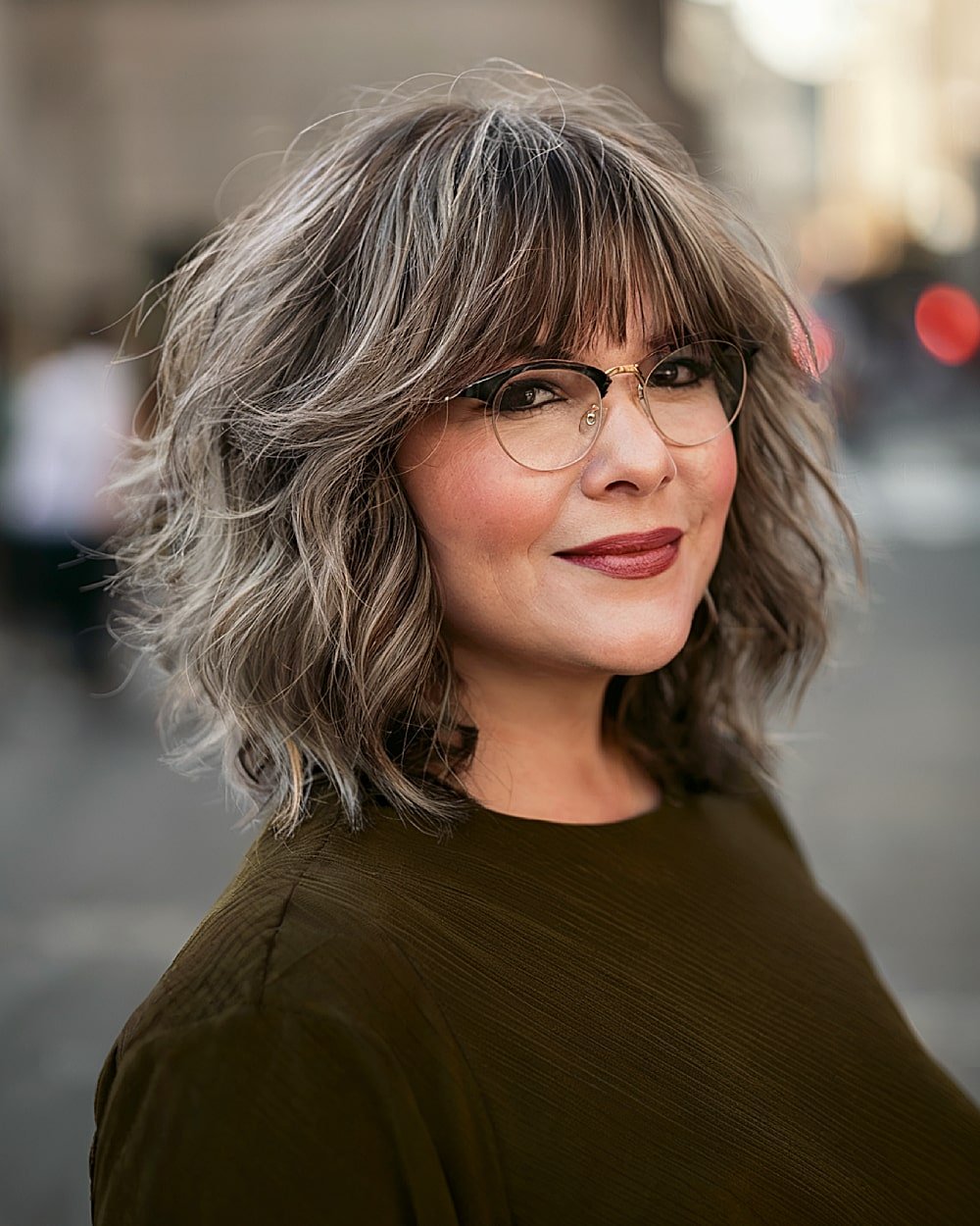 Medium shag haircut with layered ends and full fringe for alternative hair texture